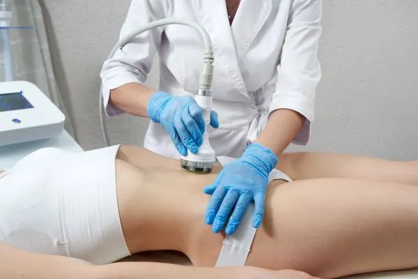 Lost the Weight but Not the Loose Skin? 2 woman having HIFU treatment on her stomach to combat loose skin Derby following weight loss
